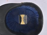 a black hat with a blue band and a gold x on it