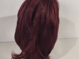 a close up of a wig on a mannequin head on a white surface