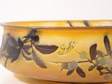 a yellow bowl with a design on it on a table