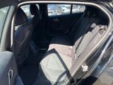 a black car with its door open in a parking lot