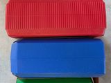 several different colored plastic containers stacked on top of each other