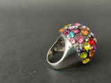 a close up of a colorful ring on a black surface