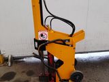 a close up of a small machine on the ground near a building