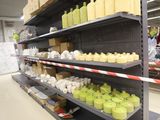 many bottles of juice on the shelves in the store