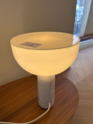 a lamp that is sitting on a table in a room