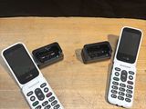 three cell phones sitting on a wooden table next to each other