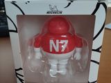 a red and white figure in a box on a table