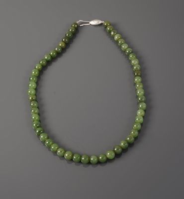 a green jade beaded necklace with a silver clasp