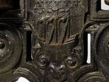 a close up of a metal object with a face on it