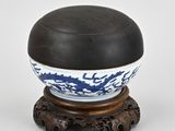 chinese blue and white porcelain bowl on wooden stand on white background