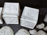many pieces of white clay that are on a table
