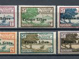 quatre timbres différents représentant des arbres sur un fond noir