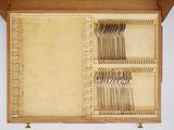 a wooden box with a bunch of silverware in it