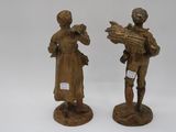 pair of antique bronze figurines of a man and a woman