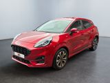 a red ford karry parked in a room with a black floor