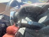 a person holding a cell phone in their hand while driving a car