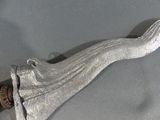 a silver knife that is laying on a table