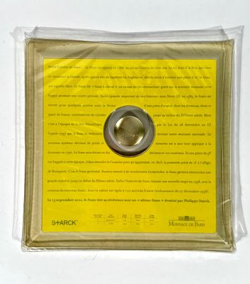 a picture of a piece of paper with a button on it
