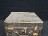 an old suitcase sitting on a black surface