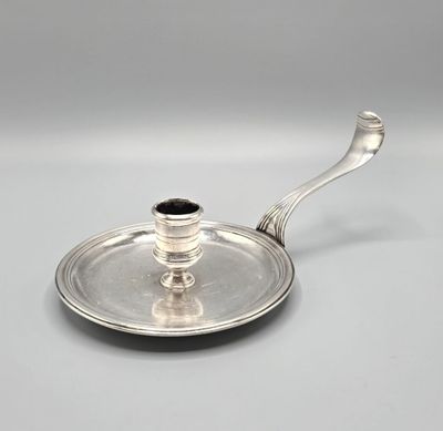 a silver plate with a handle and a handle on it