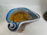 a blue and yellow glass bowl sitting on a white counter