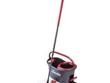 a red and black mop sitting on top of a black bucket