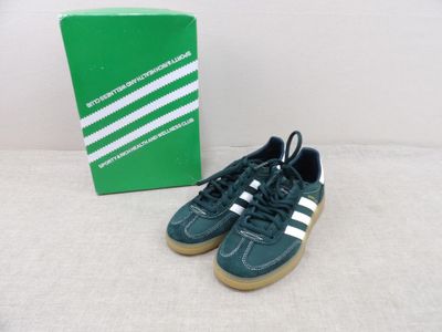 green and white adidas sneakers next to a box of green and white shoes