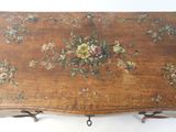 a wooden table with a floral design on it