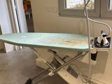 an ironing board sitting on top of an ironing board stand