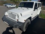 a white jeep parked in a parking lot next to other cars