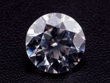 a close up of a diamond on a black surface