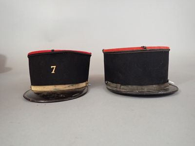 pair of black and red hats with numbers on them sitting on a plate