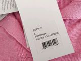 the label on a pink sweater is attached to a white tag