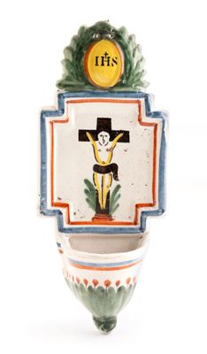 a picture of a ceramic crucifix hanging on a wall