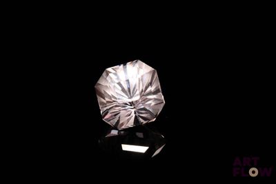 a close up of a diamond on a black surface