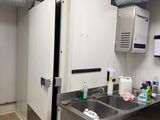 a kitchen with a sink and a refrigerator in it
