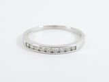 a close up of a diamond ring on a white surface