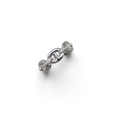 a close up of a ring with diamonds on a white surface