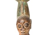 an image of a wooden statue with a head on top of it