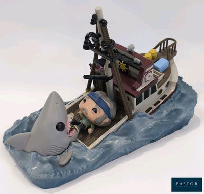 a figurine of a man in a boat with a shark