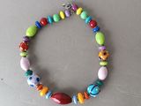 a close up of a bracelet with colorful beads on a table