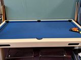 a pool table with a blue cloth on it in a room
