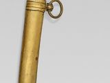 a gold colored dagger with a black handle and a gold colored blade