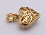 a close up of a gold heart shaped pendant with diamonds on it