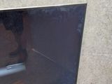 a flat screen tv sitting on top of a wooden stand