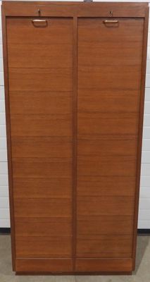 une armoire en bois à deux portes, avec un tiroir en dessous