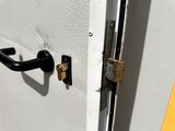 a close up of a door handle on a white door