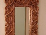 a mirror on the wall above a sink in a bathroom