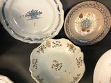 many different types of plates and bowls on the table