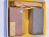 two books in a box on a white surface